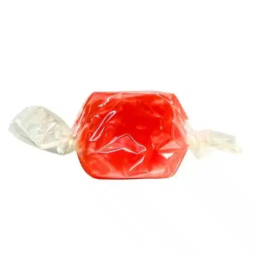 A wrapped cherry-flavored Derived Creations Delta 9 CBD taffy, highlighting its bright red color and smooth texture for a fruity 2:1 edible experience.